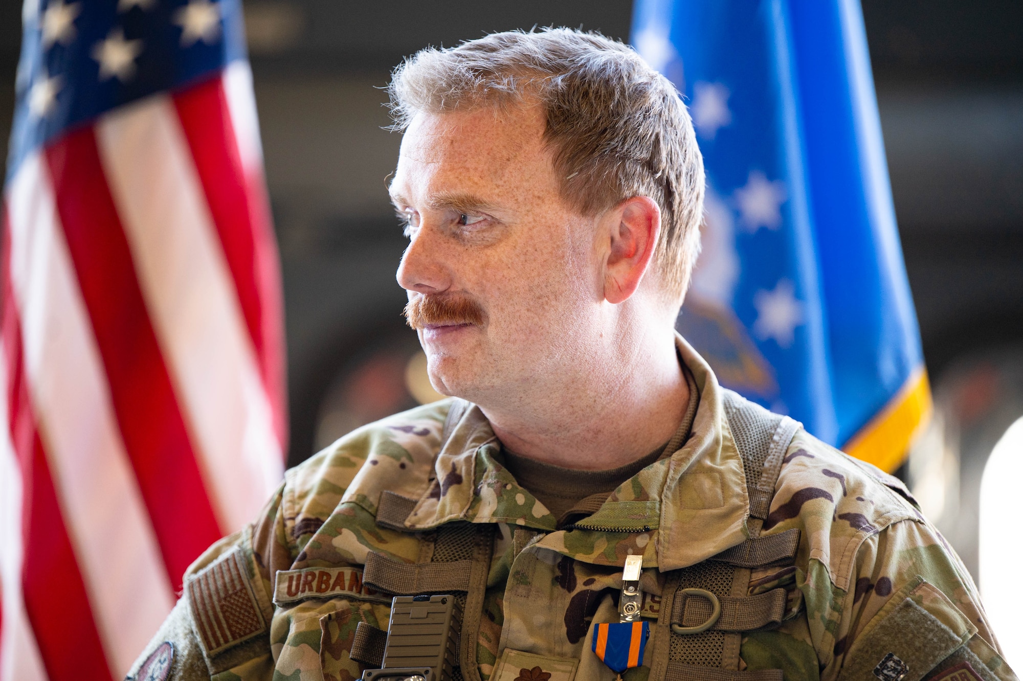 A man in uniform smiles.