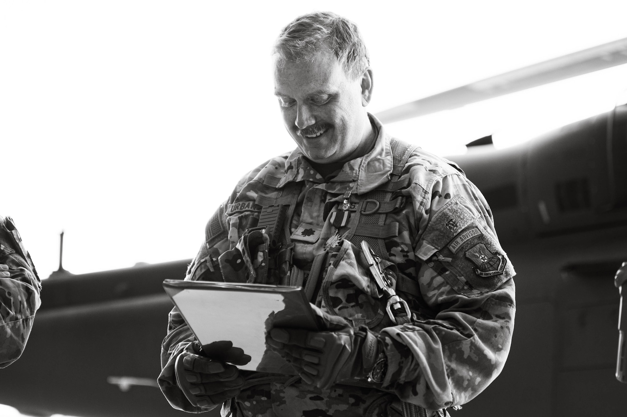 A man in uniform looks at a document.