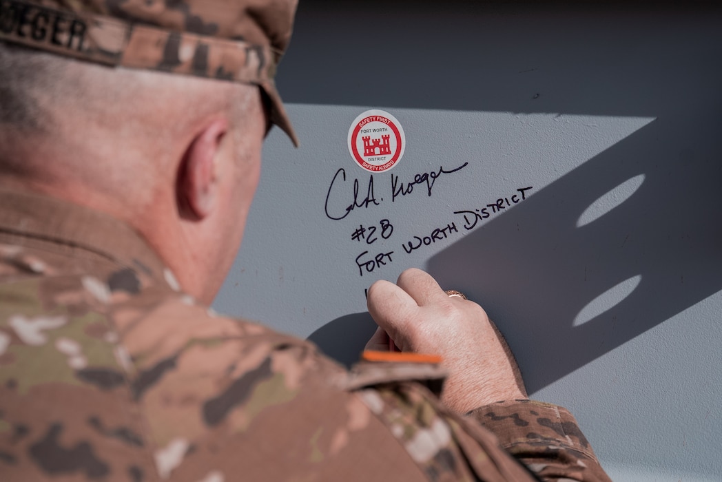 Col. Kroeger signs the beam used for the topping off ceremony