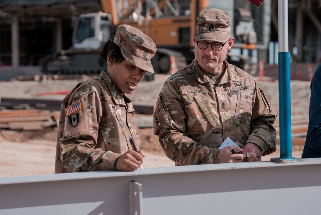 Soldiers from BAMC sign beam used for topping off ceremony