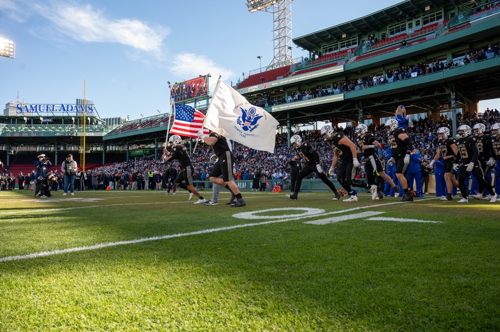 U.S. Coast Guard Academy (USCGA) football players run onto the field during the 54th Secretaries’ Cup at Fenway Park, Boston, Nov. 15, 2025. USCGA won last year’s Secretaries’ Cup, ending the game with a 42-21 score against the U.S. Merchant Marine Academy. (U.S. Coast Guard photo by Petty Officer Third Class Leo Avila.)