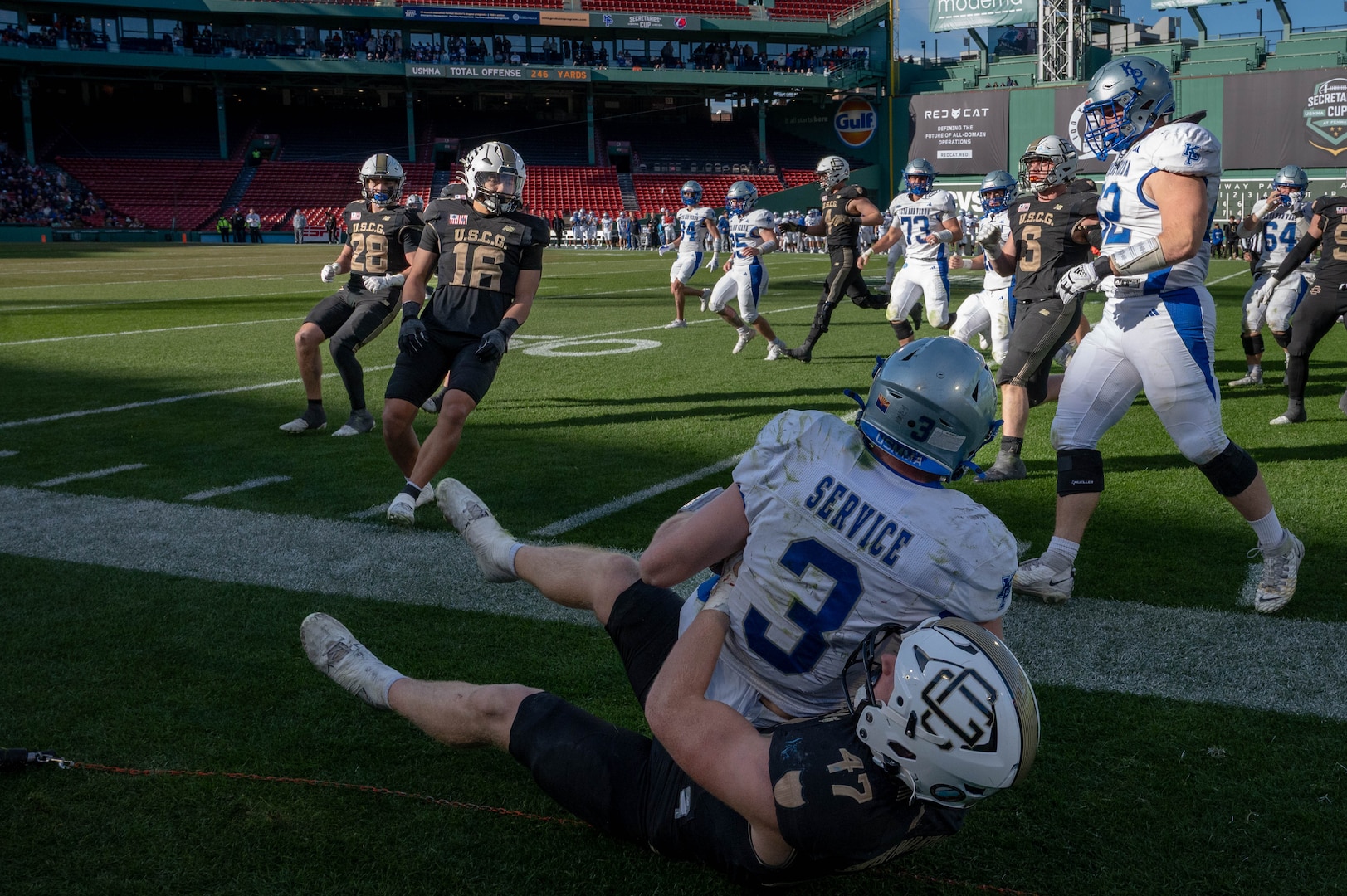 U.S. Coast Guard Academy football player tackles a U.S. Merchant Marine Academy football player during the 54th Secretaries’ Cup at Fenway Park, Boston, Nov. 15, 2025. Fenway Park hosted the 54th Secretaries Cup, giving both service academies a national stage to showcase their hard work and dedication. (U.S. Coast Guard photo by Petty Officer Third Class Leo Avila.)