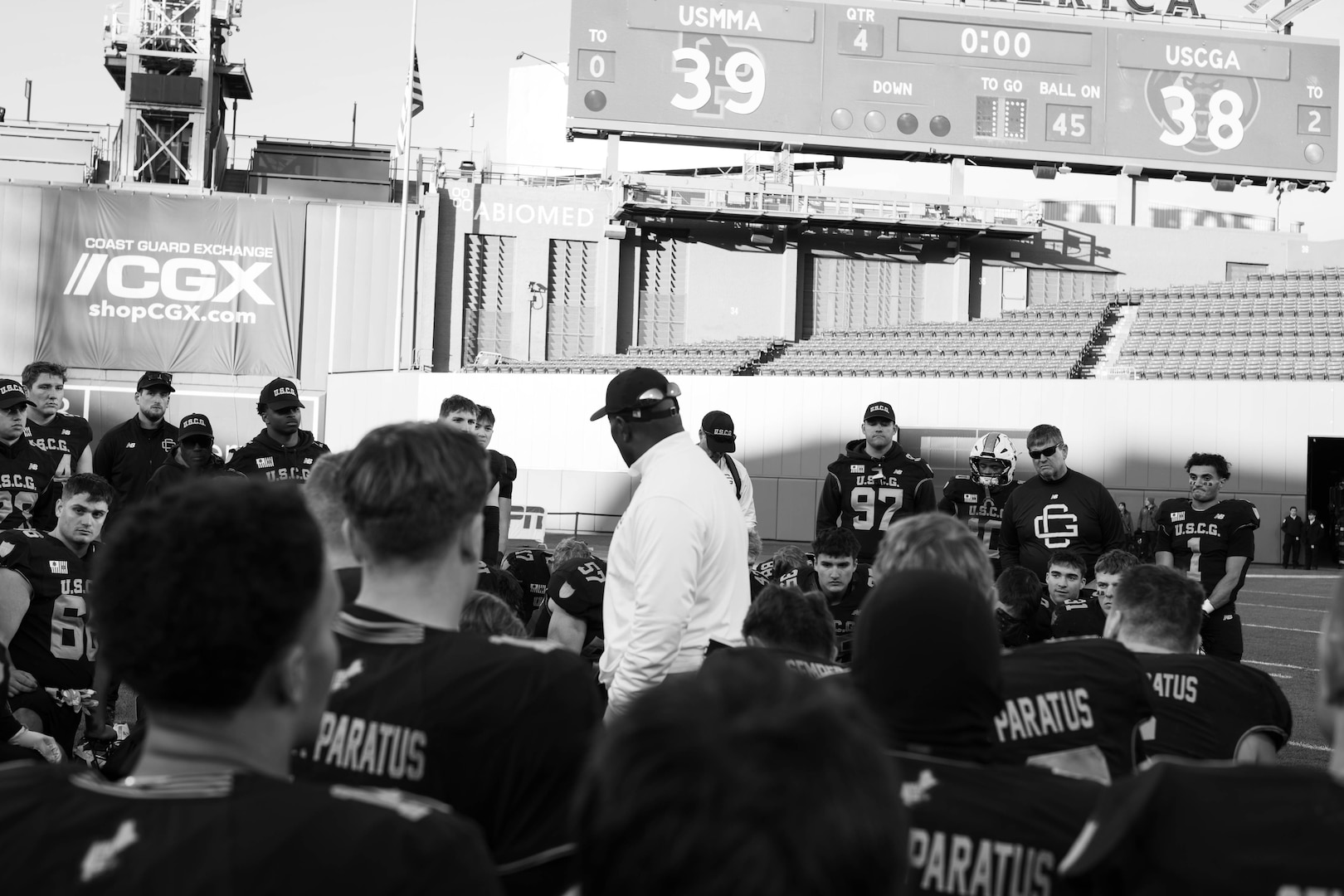 U.S. Coast Guard Academy football team take a knee after playing the 54th Secretaries’ Cup at Fenway Park, Boston, Nov. 15, 2025. In 2003, “Secretary's Cup” was pluralized when the U.S. Coast Guard moved to the Department of Homeland Security. (U.S. Coast Guard photo by Petty Officer Second Class Janessa Warshckow.)