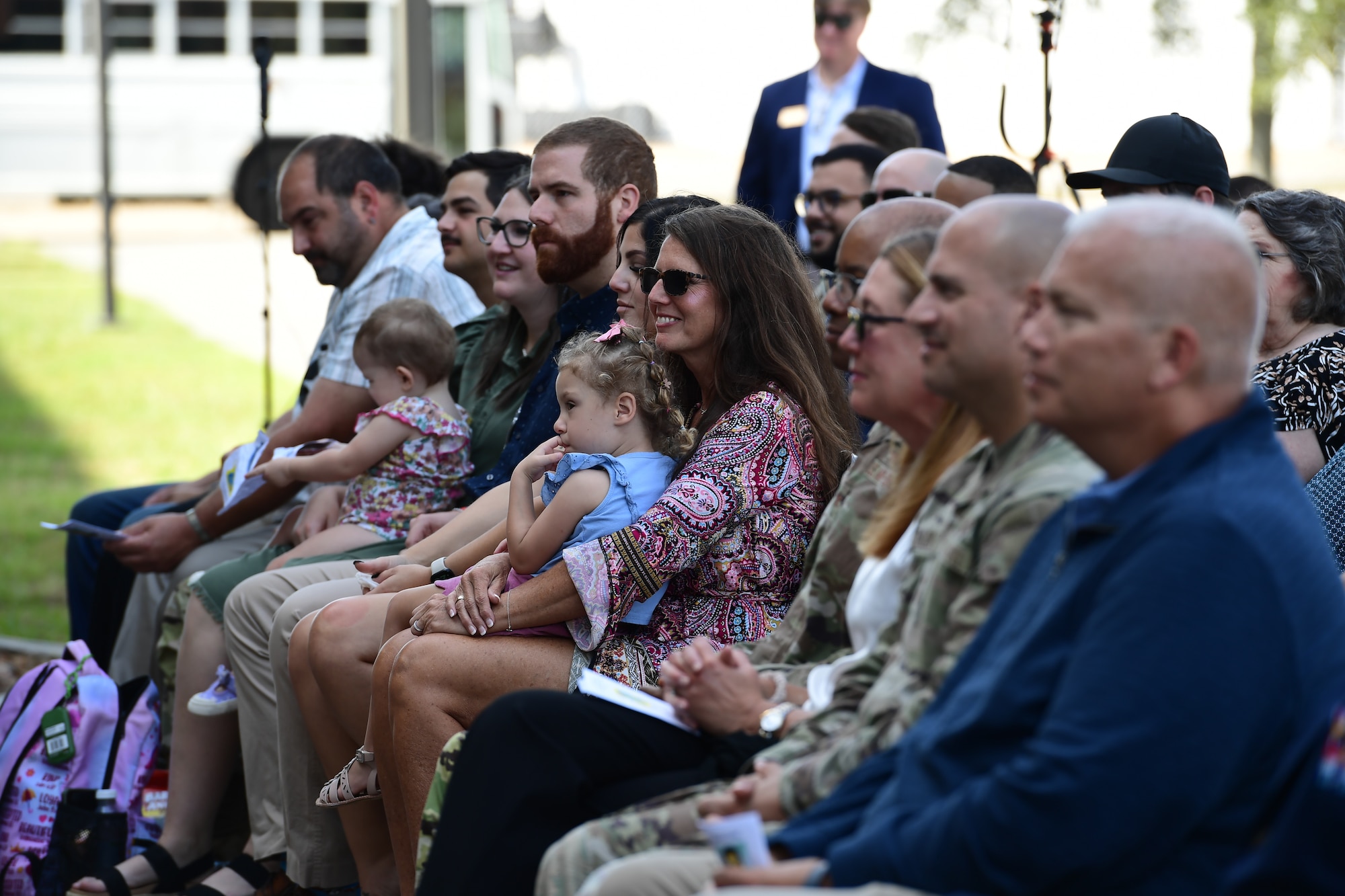 A group of people sit in a crowd