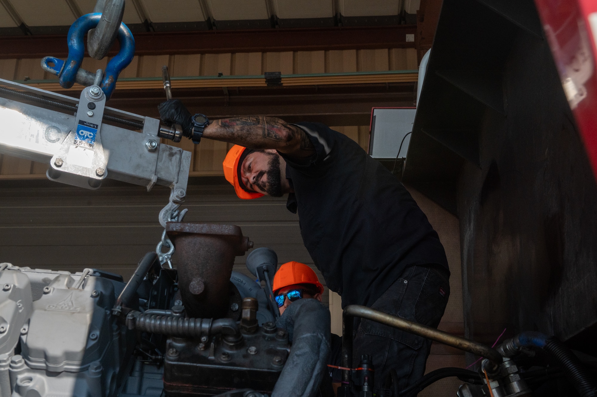 Man works on engine.