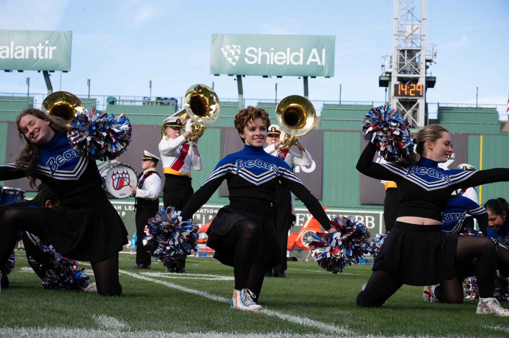 U.S. Coast Guard Academy (USCGA) cheerleaders pose during the 54th Secretaries' Cup halftime show at Fenway Park, Boston, Nov. 15, 2025. This is the first time USCGA and the U.S. Merchant Marine Academy have played outside of their home fields for a Secretaries’ Cup game. (U.S. Coast Guard photo by Petty Officer Third Class Leo Avila.)
