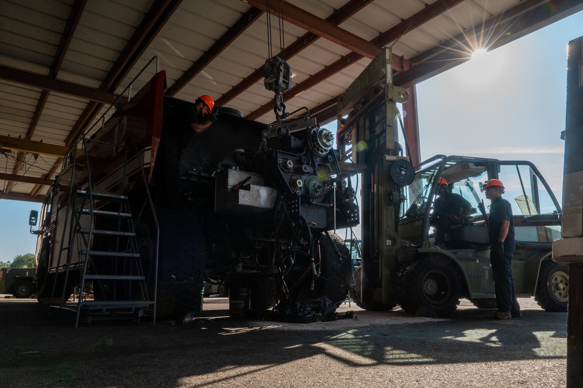 Men work on machinery.