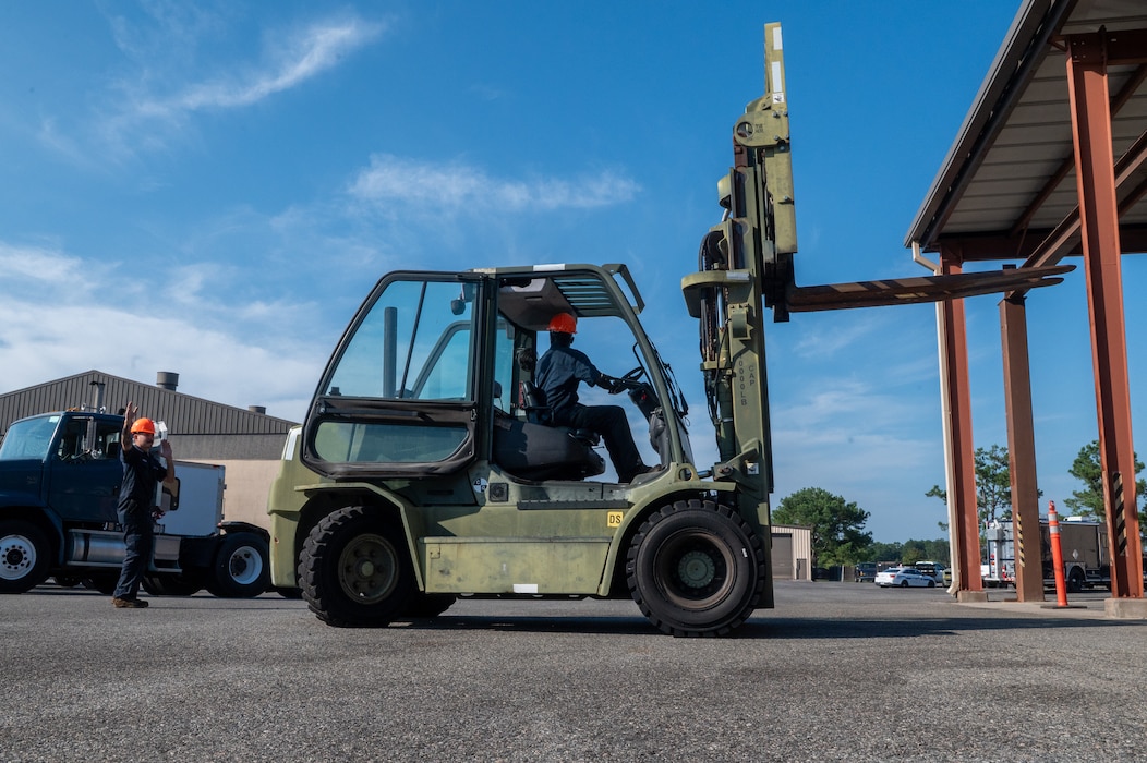 Men work with forklift.