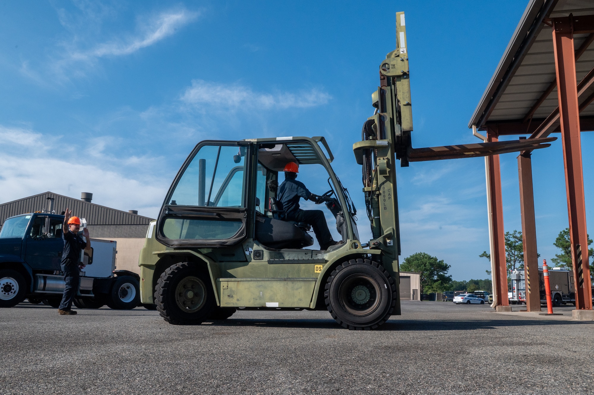 Men work with forklift.