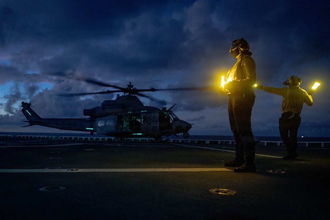U.S. Marines with Marine Medium Tiltrotor Squadron (VMM) 263 (Reinforced), 22nd Marine Expeditionary Unit (Special Operations Capable), and Sailors with San Antonio-class amphibious transport dock USS Fort Lauderdale (LPD 28) prepare an UH-1Y Venom helicopter for flight operations while underway in the Caribbean Sea, Nov. 17, 2025. U.S. military forces are deployed to the Caribbean in support of the U.S. Southern Command mission, Department of War-directed operations, and the president's priorities to disrupt illicit drug trafficking and protect the homeland. (U.S. Marine Corps photo)