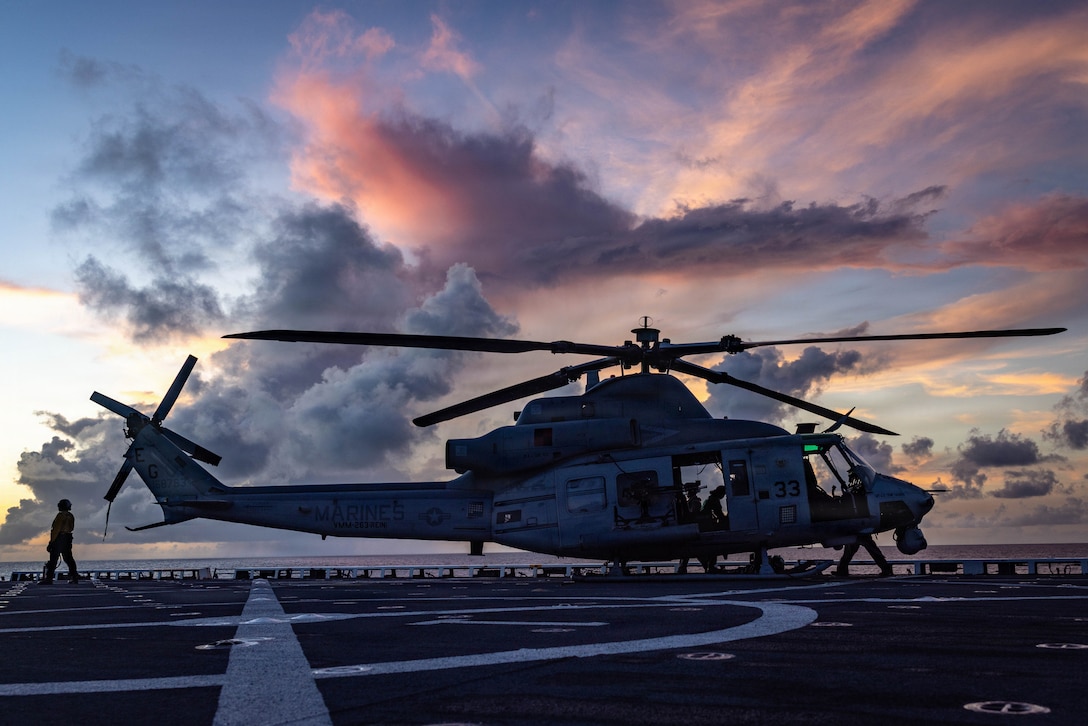 U.S. Marines with Marine Medium Tiltrotor Squadron (VMM) 263 (Reinforced), 22nd Marine Expeditionary Unit (Special Operations Capable), and Sailors with San Antonio-class amphibious transport dock USS Fort Lauderdale (LPD 28) prepare an UH-1Y Venom helicopter for flight operations while underway in the Caribbean Sea, Nov. 17, 2025. U.S. military forces are deployed to the Caribbean in support of the U.S. Southern Command mission, Department of War-directed operations, and the president's priorities to disrupt illicit drug trafficking and protect the homeland. (U.S. Marine Corps photo)