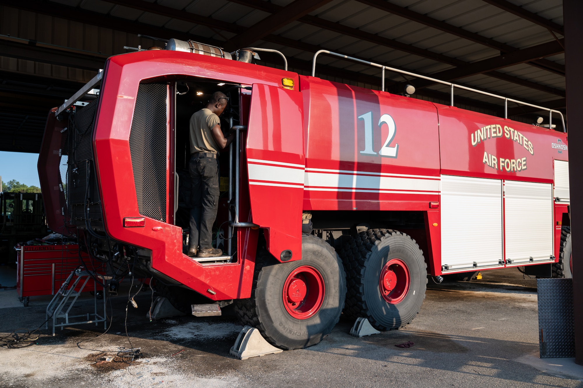 Man works on firetruck.