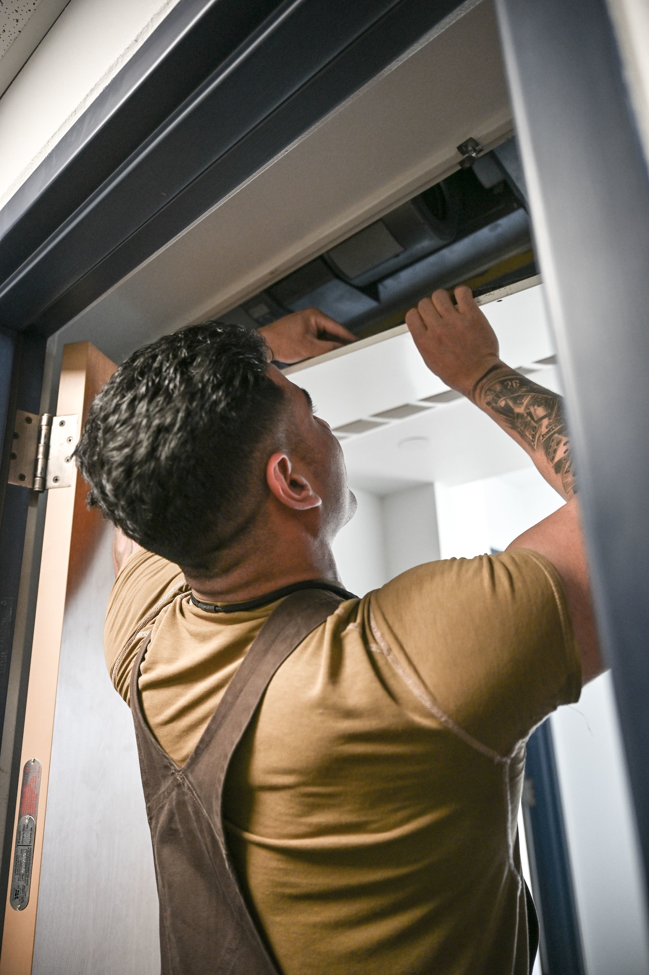 A man hiding chemical components of an explosive device in the ceiling.
