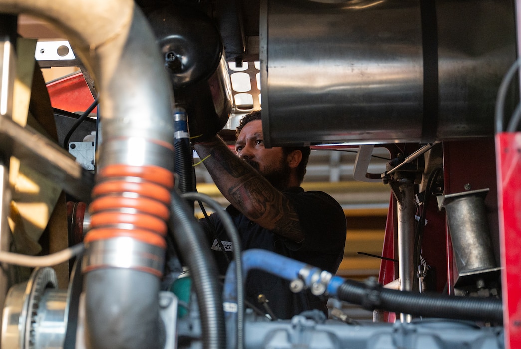 Man works on engine.