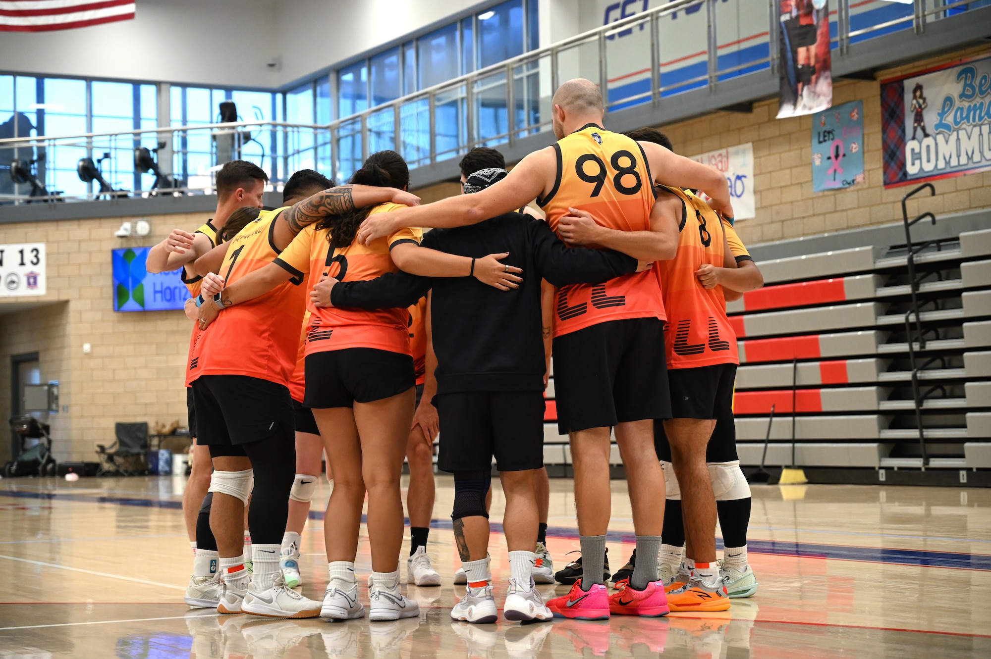 This image portrays Hill AFB's volleyball team playing against other bases at an Air Force Varsity Volleyball League tournament.