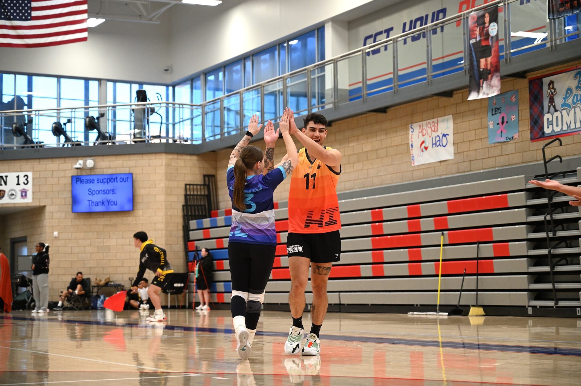 This image portrays Hill AFB's volleyball team playing against other bases at an Air Force Varsity Volleyball League tournament.