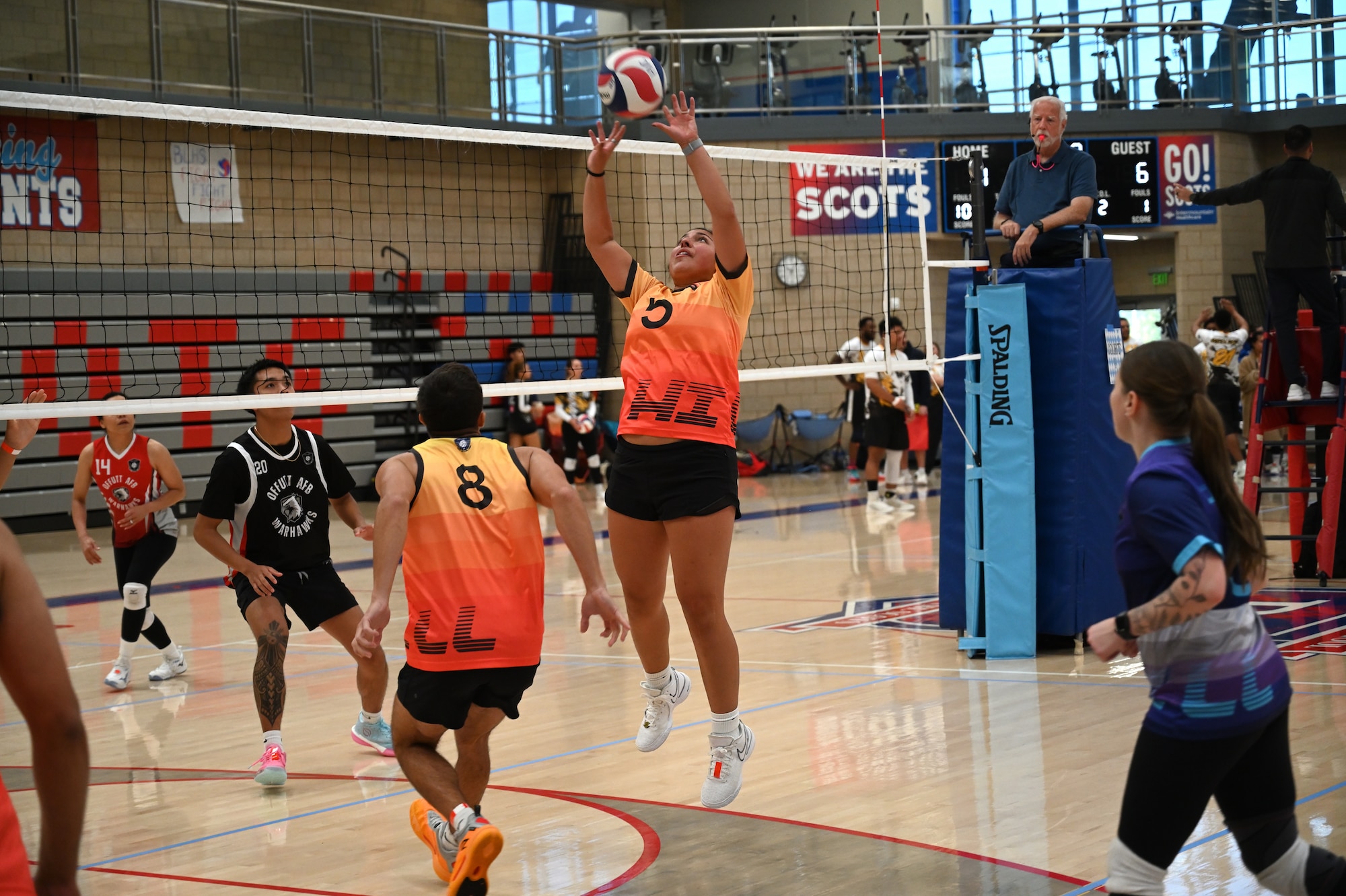 This image portrays Hill AFB's volleyball team playing against other bases at an Air Force Varsity Volleyball League tournament.