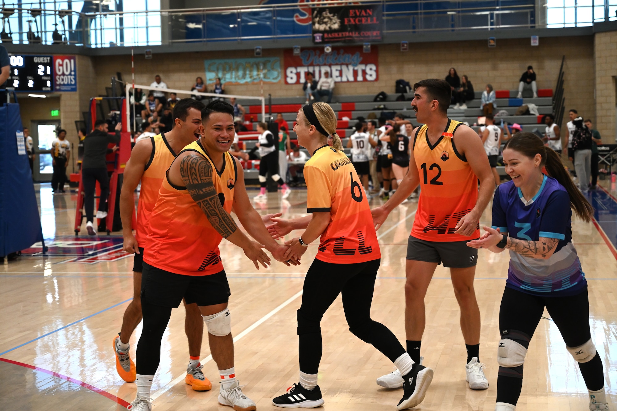 This image portrays Hill AFB's volleyball team playing against other bases at an Air Force Varsity Volleyball League tournament.
