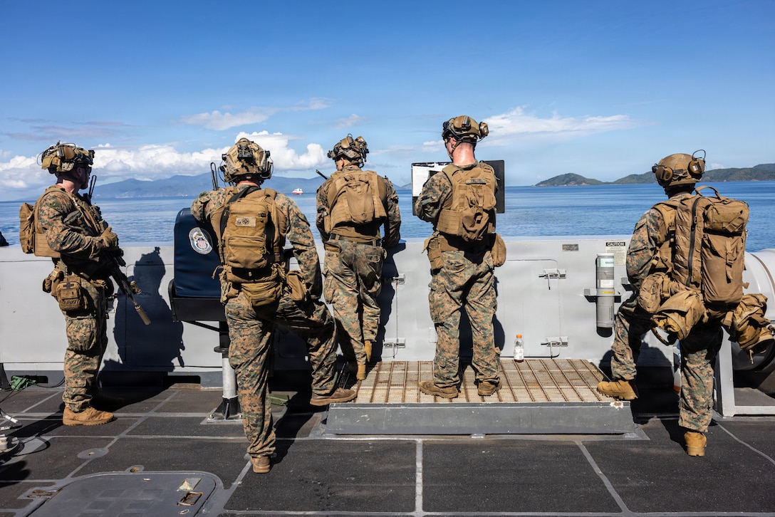 U.S. Marines with India Company, Battalion Landing Team 3/6, 22nd Marine Expeditionary Unit (Special Operations Capable), observe the operating area aboard San Antonio-class amphibious transport dock USS Fort Lauderdale (LPD 28) during a strait transit while underway in the Caribbean Sea, Nov. 18, 2025. U.S. military forces are deployed to the Caribbean in support of the U.S. Southern Command mission, Department of War-directed operations, and the president's priorities to disrupt illicit drug trafficking and protect the homeland. (U.S. Marine Corps photo)