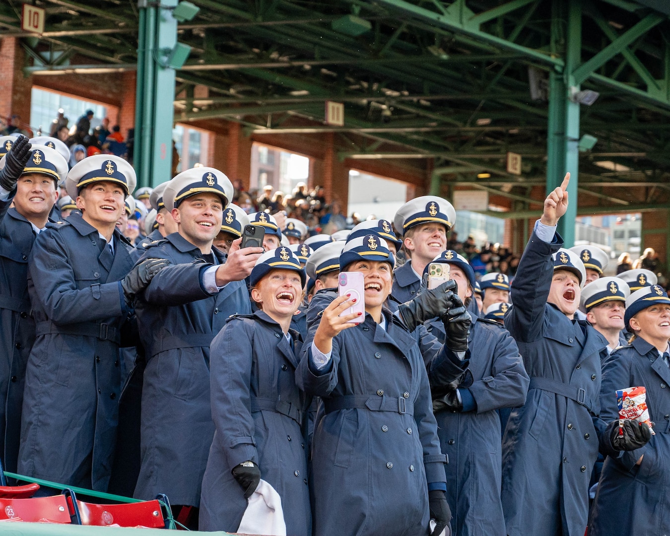 U.S. Coast Guard Academy (USCGA) cadets cheer during the 54th Secretaries' Cup at Fenway Park, Boston, Nov. 15, 2025. In 2003, "Secretary's Cup" was pluralized when the U.S. Coast Guard moved to the Department of Homeland Security. (U.S. Coast Guard photo by Petty Officer Third Class Leo Avila.)