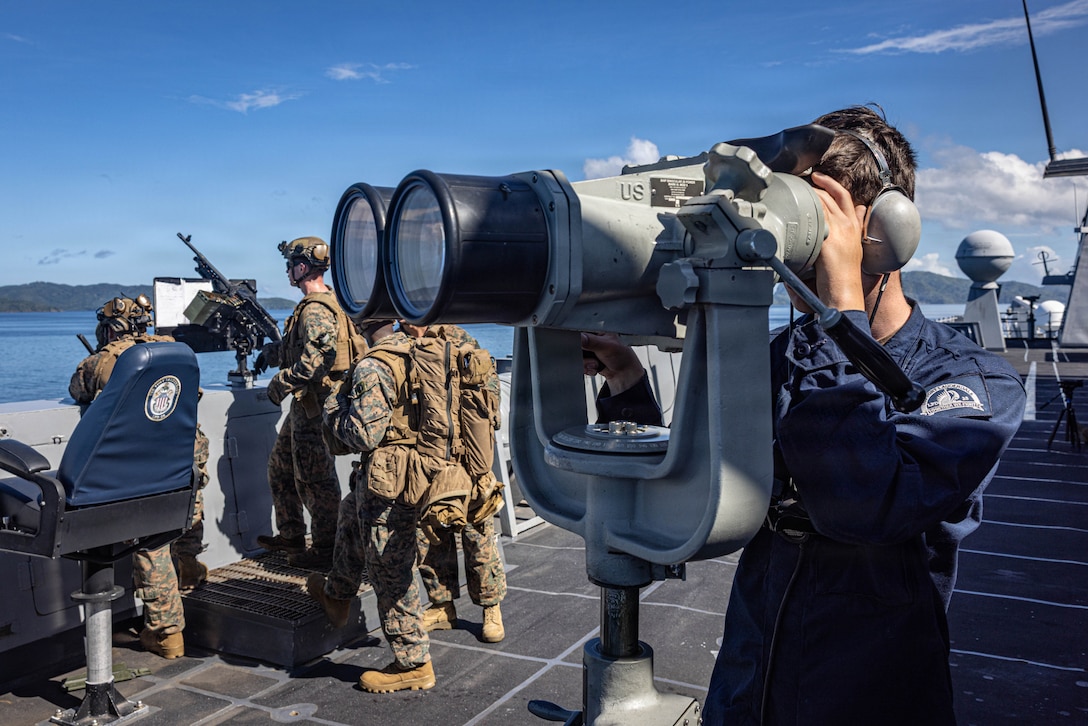 U.S. Marines with India Company, Battalion Landing Team 3/6, 22nd Marine Expeditionary Unit (Special Operations Capable), and Sailors assigned to San Antonio-class amphibious transport dock USS Fort Lauderdale (LPD 28) observe the operating area during a strait transit while underway in the Caribbean Sea, Nov. 18, 2025. U.S. military forces are deployed to the Caribbean in support of the U.S. Southern Command mission, Department of War-directed operations, and the president's priorities to disrupt illicit drug trafficking and protect the homeland. (U.S. Marine Corps photo)