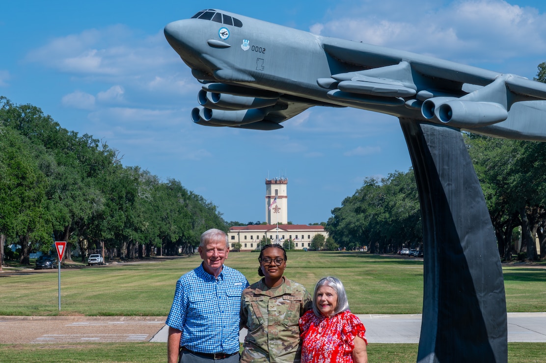 U.S. Air Force Senior Airman Janelee Roches, 2nd Comptroller Squadron commander’s support staff force management technician, takes a group photo with John and Melody Rodland, at Barksdale Air Force Base, Louisiana, Oct. 12, 2025. John and Melody volunteered for Barksdale’s Adopt an Airman support program which offers Airmen at Barksdale a new support system by matching with local volunteer family members, gaining a new home away from home. (U.S. Air Force photo by Airman 1st Class Preston Crawford)