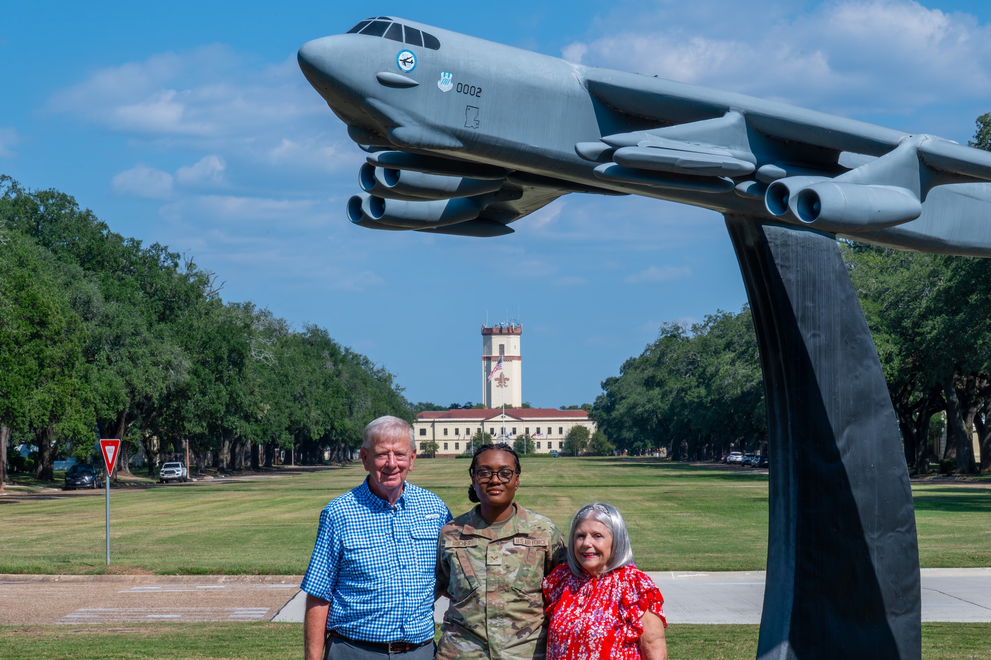 U.S. Air Force Senior Airman Janelee Roches, 2nd Comptroller Squadron commander’s support staff force management technician, takes a group photo with John and Melody Rodland, at Barksdale Air Force Base, Louisiana, Oct. 12, 2025. John and Melody volunteered for Barksdale’s Adopt an Airman support program which offers Airmen at Barksdale a new support system by matching with local volunteer family members, gaining a new home away from home. (U.S. Air Force photo by Airman 1st Class Preston Crawford)