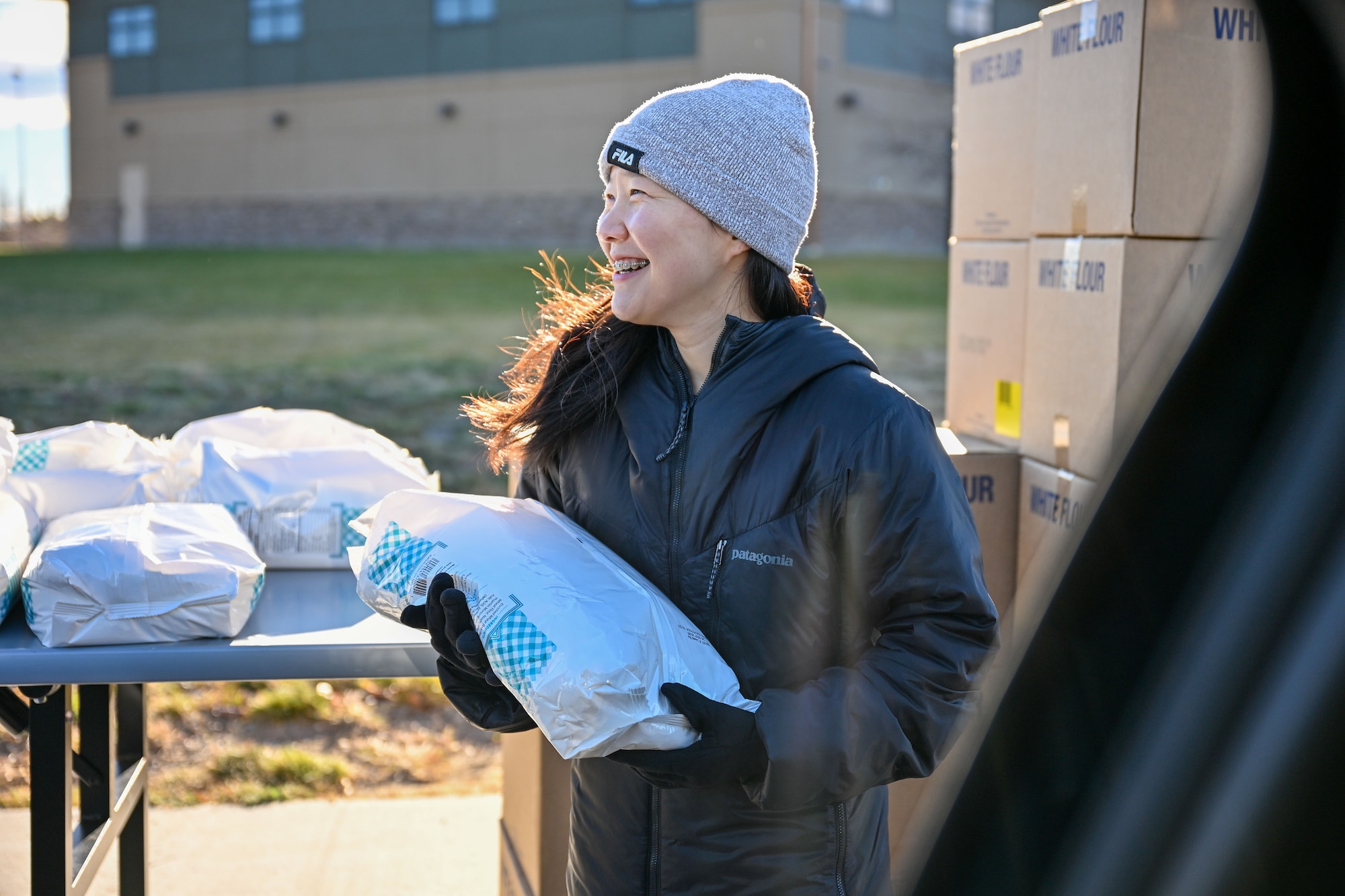 A woman holding a bag of flour.