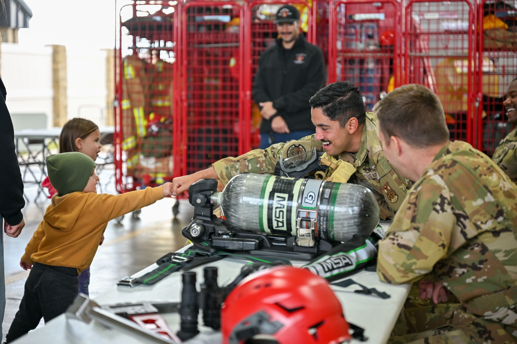An Airman fist-bumping a child.