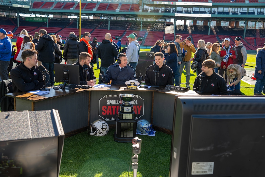U.S. Coast Guard Academy (USCGA) Superintendent Rear Adm. Gregory Rothrock (middle) having a pregame discussion with the hosts of the D1 Rejects podcast at the 54th Secretaries’ Cup at Fenway Park, Boston, Nov. 15, 2025. The location of the 54th Secretaries’ Cup is significant for being in a major League stadium in the heart of New England, the birthplace of the U.S. Coast Guard. (U.S. Coast Guard photo by Petty Officer Second Class Janessa Warshckow.)