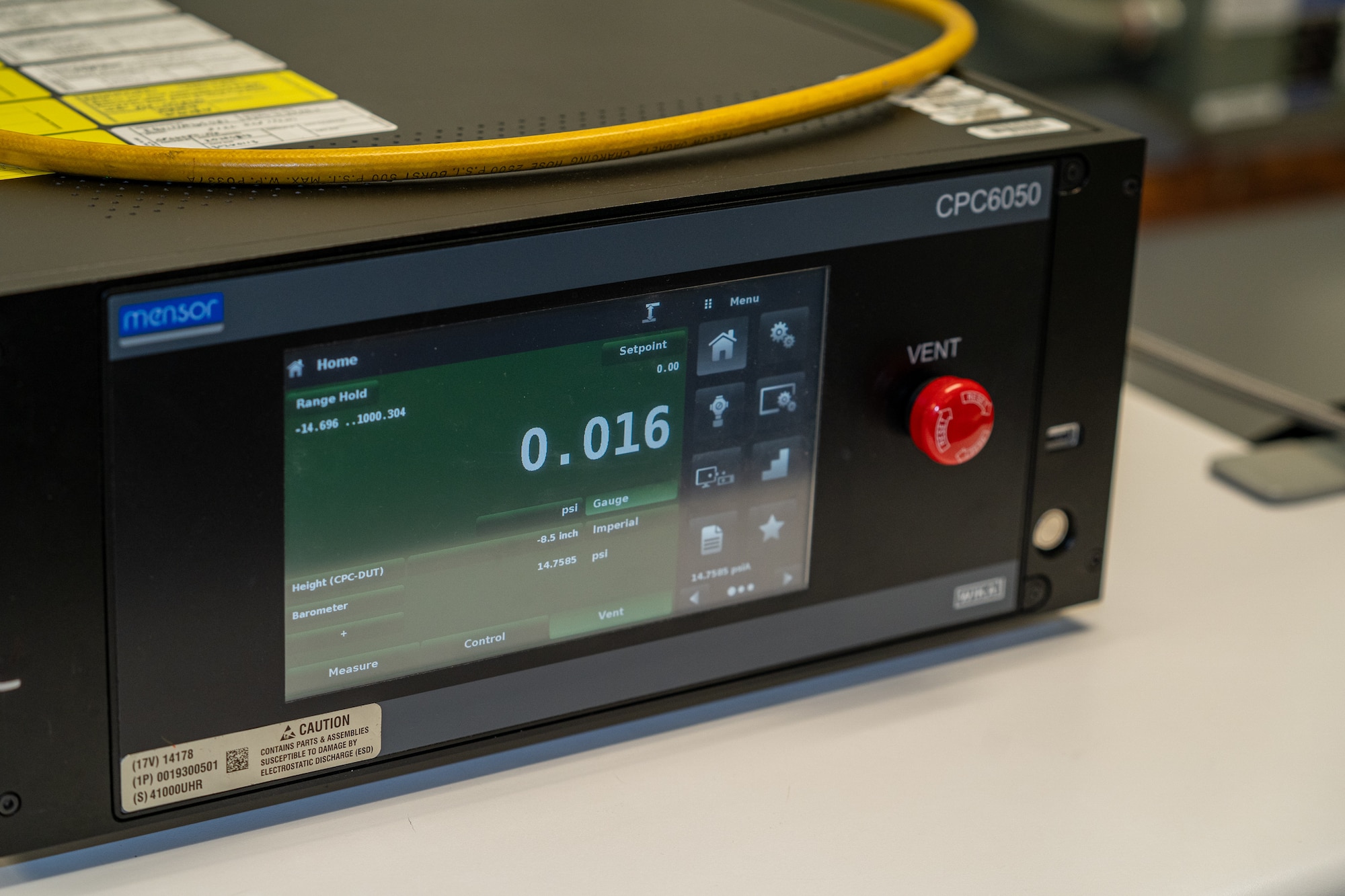 A calibrator with a green display.