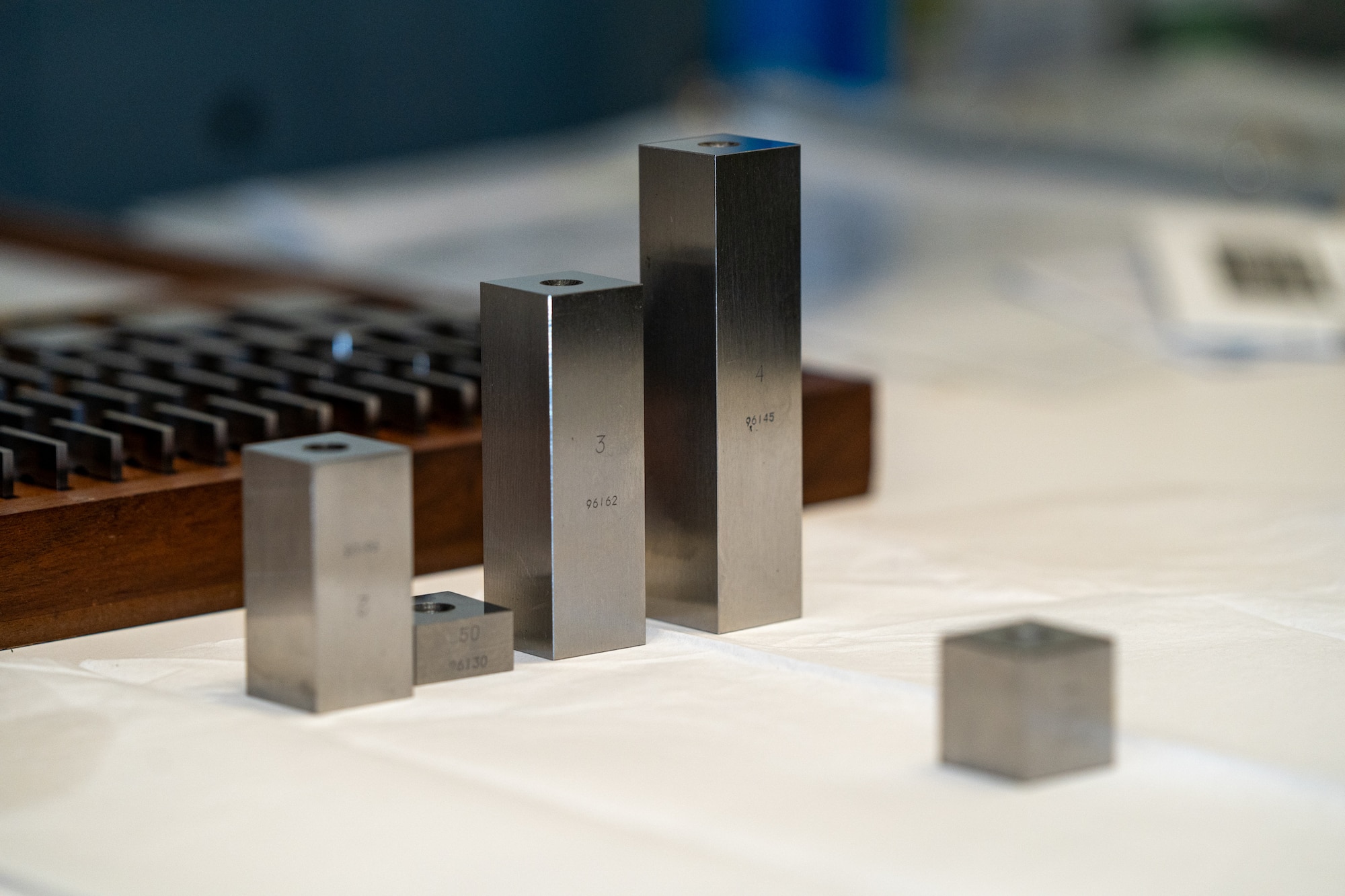 Three gauge blocks sit on a table.
