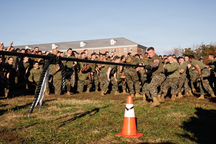 U.S. Marines with The Basic School, Training Command, compete in a tug-of-war during a field meet at Marine Corps Base Quantico, Virginia, Oct. 31, 2025.  During the field meet, Marines with TBS participated in physical training and competitions to build camaraderie and celebrate the Marine Corps' 250th Birthday. (U.S. Marine Corps photo by Cpl. Joshua Barker)