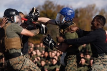 U.S. Marines with The Basic School, Training Command, compete in a weapons free-sparring event during a field meet at Marine Corps Base Quantico, Virginia, Oct. 31, 2025.  During the field meet, Marines with TBS participated in physical training and competitions to build camaraderie and celebrate the Marine Corps' 250th Birthday. (U.S. Marine Corps photo by Cpl. Joshua Barker)