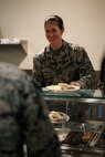 U.S. Marine Corps Capt. Kelly Owen, an infantry officer and the executive officer of Company D, Basic Officer Course 4-25, The Basic School, serves food during the Warrior’s Breakfast at TBS, Marine Corps Base Quantico, Virginia, Nov. 20, 2025. The Warrior’s breakfast follows the Warfighting Field Exercise, which serves as the culminating event at TBS, evaluating students’ proficiency in decision-making, small-unit tactics, and leadership as they operate under sustained physical and mental pressure in a realistic warfighting scenario. (U.S. Marine Corps photo by Cpl. Joshua Barker)