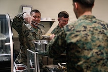 U.S. Marine Corps Maj. Brett Disher, company commander, Company D, Basic Officer Course 4-25, The Basic School, serves food during the Warrior’s Breakfast at TBS, Marine Corps Base Quantico, Virginia, Nov. 20, 2025. The Warrior’s breakfast follows the Warfighting Field Exercise, which serves as the culminating event at TBS, evaluating students’ proficiency in decision-making, small-unit tactics, and leadership as they operate under sustained physical and mental pressure in a realistic warfighting scenario. (U.S. Marine Corps photo by Cpl. Joshua Barker)