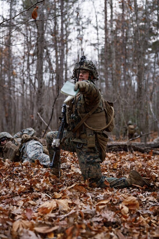 A U.S. Marine Corps student with Company D, Basic Officer Course 4-25, directs other Marines during the Warfighting Field Exercise at Marine Corps Base Quantico, Virginia, Nov. 19, 2025. The WARFEX serves as the culminating event at TBS, evaluating students’ proficiency in decision-making, small-unit tactics, and leadership as they operate under sustained physical and mental pressure in a realistic warfighting scenario. (U.S. Marine Corps photo by Cpl. Joshua Barker)