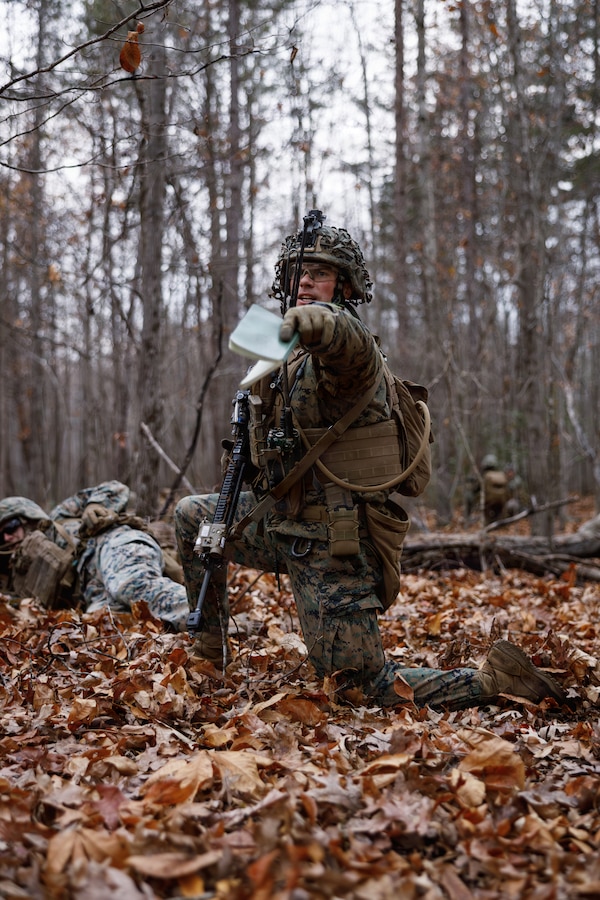 A U.S. Marine Corps student with Company D, Basic Officer Course 4-25, directs other Marines during the Warfighting Field Exercise at Marine Corps Base Quantico, Virginia, Nov. 19, 2025. The WARFEX serves as the culminating event at TBS, evaluating students’ proficiency in decision-making, small-unit tactics, and leadership as they operate under sustained physical and mental pressure in a realistic warfighting scenario. (U.S. Marine Corps photo by Cpl. Joshua Barker)