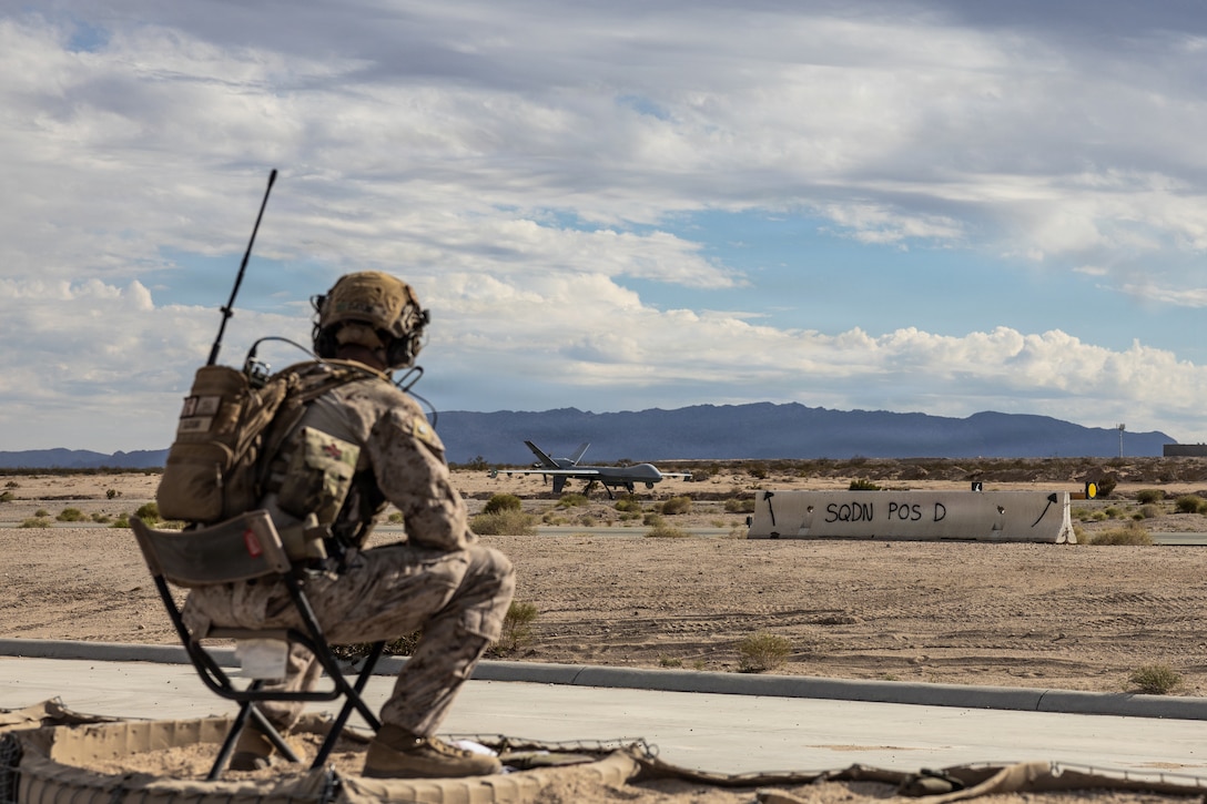 A U.S. Marine assigned to Marine Aviation Weapons and Tactics Squadron One, Marine Air Ground Task Force Training Command, Training and Education Command guides a Marine Corps MQ-9 Reaper Unmanned Aircraft System conducting Satellite Launch and Recovery training as part of Weapons and Tactics Instructor Course 1-26 at the Strategic Expeditionary Landing Field, Marine Corps Air Ground Combat Center, Twentynine Palms, California, Oct. 21, 2025. The SLR capability enhances the expeditionary employment of the MQ-9, enabling aircrews to launch and recover the UAS through satellite control without reliance on traditional line-of-sight infrastructure. This capability directly supports the Marine Corps’ objectives for distributed Maritime operations and stand-in force employment by providing persistent Intelligence Surveillance Reconnaissance and Strike options from austere location. (U.S. Marine Corps photo by 1st Lt. Kristian Floyd)