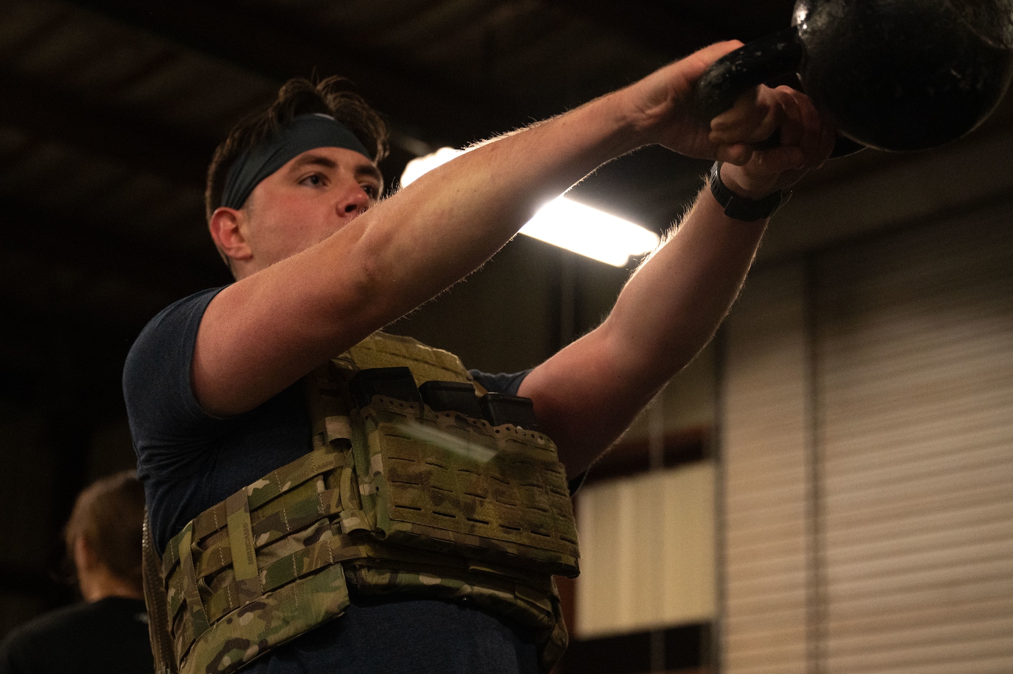 U.S. Air Force Airman 1st Class Wyatt Henton, 355th Civil Engineer Squadron explosive ordnance disposal technician, performs a kettlebell swing during the Salute in Motion memorial at Davis-Monthan Air Force Base, Arizona, Nov. 21, 2025. Salute in Motion is an annual memorial workout honoring the 345 EOD service members who lost their lives in the line of duty. (U.S. Air Force photo by Airman 1st Class Jaden Kidd)