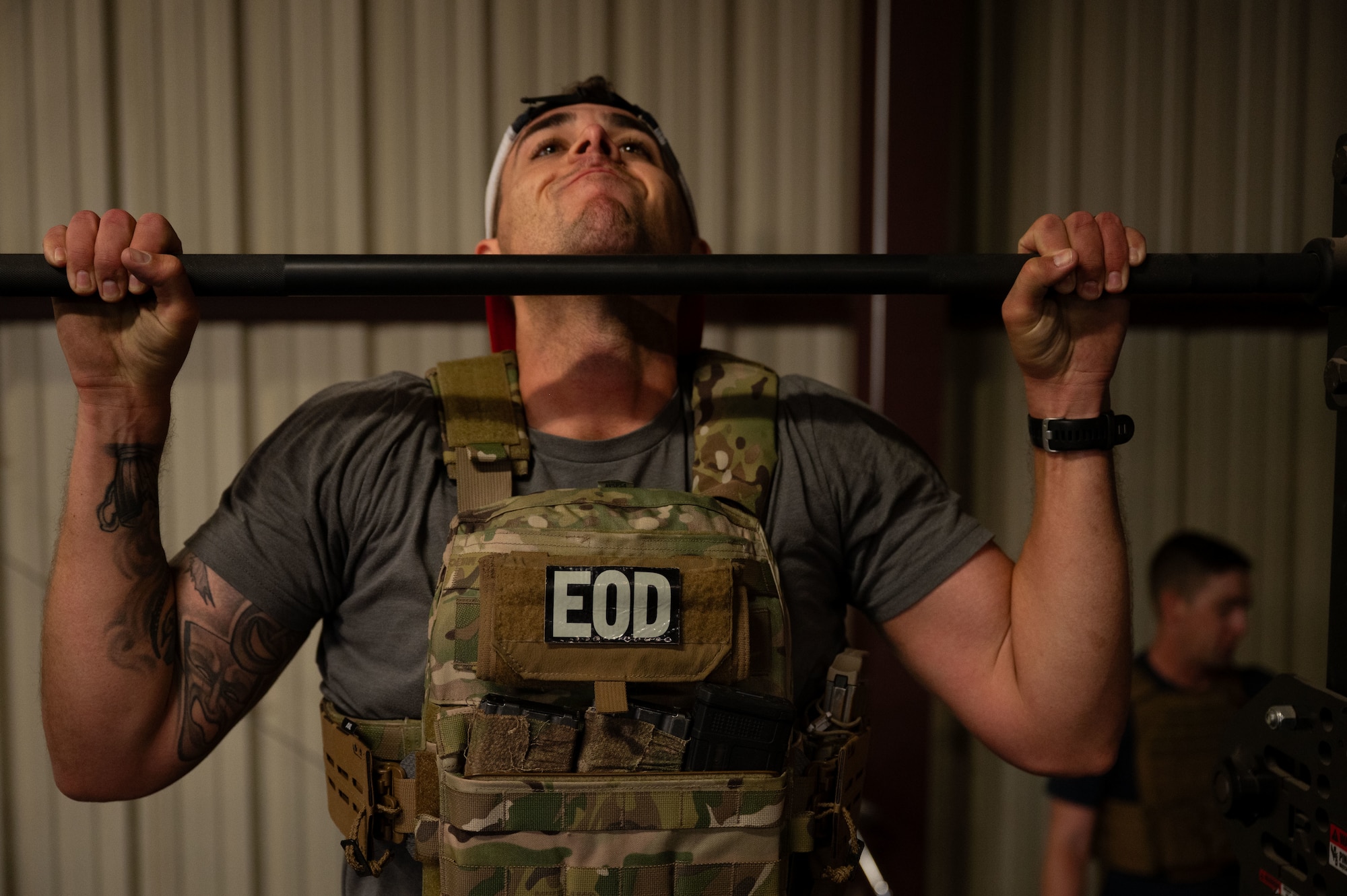 U.S. Air Force Staff Sgt. Alexander Mason, 355th Civil Engineer Squadron explosive ordnance disposal technician, performs a pull-up during the Salute in Motion memorial at Davis-Monthan Air Force Base, Arizona, Nov. 21, 2025. EOD Airmen participated in Salute in Motion, an annual memorial honoring the 345 EOD Airmen who lost their lives in the line of duty. (U.S. Air Force photo by Airman 1st Class Jaden Kidd)