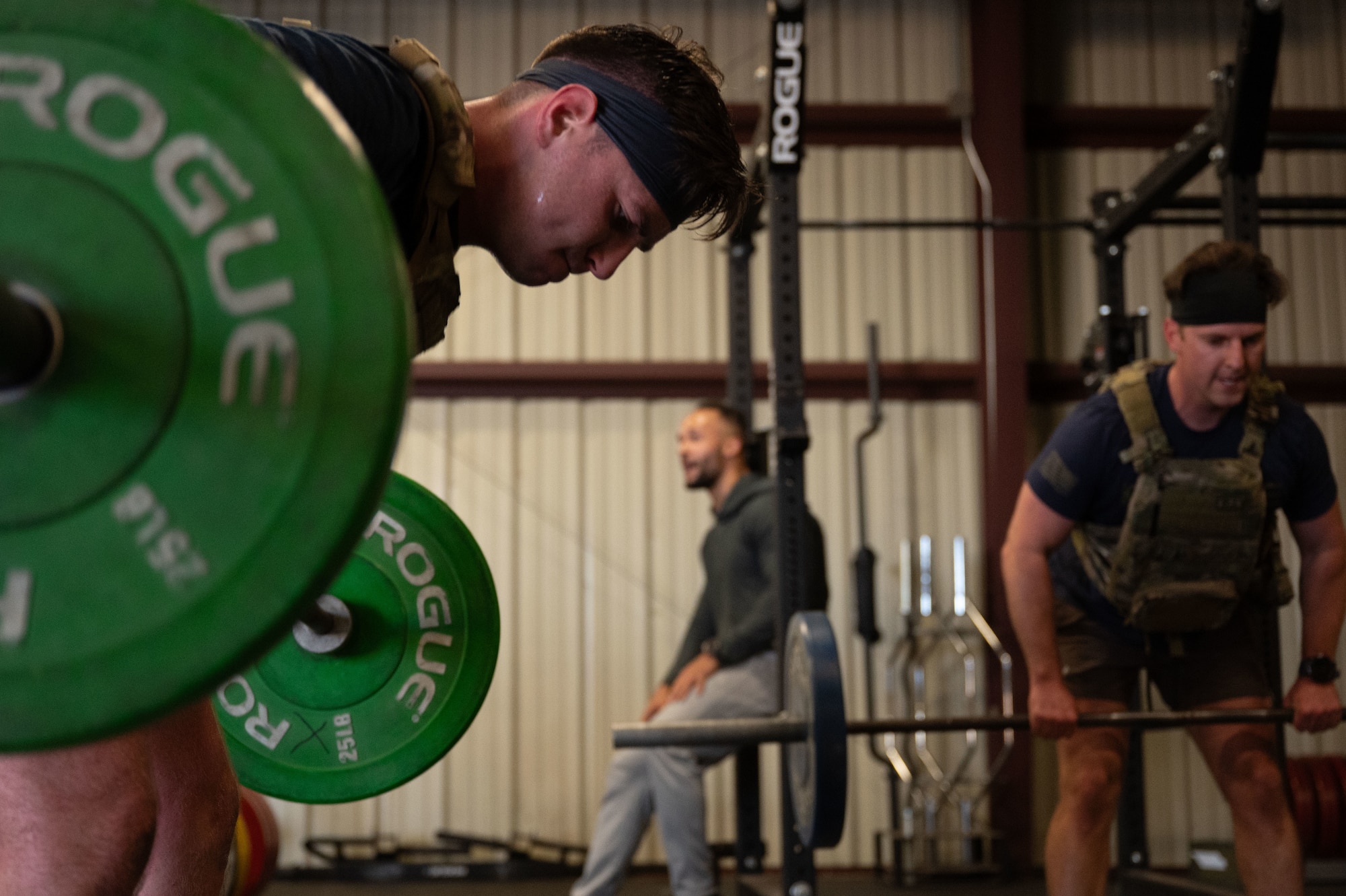 U.S. Air Force Airman 1st Class Wyatt Henton, 355th Civil Engineer Squadron explosive ordnance disposal technician, performs a barbell row during the Salute in Motion memorial at Davis-Monthan Air Force Base, Arizona, Nov. 21, 2025. Salute in Motion is an annual memorial honoring EOD service members who lost their lives in the line of duty. (U.S. Air Force photo by Airman 1st Class Jaden Kidd)