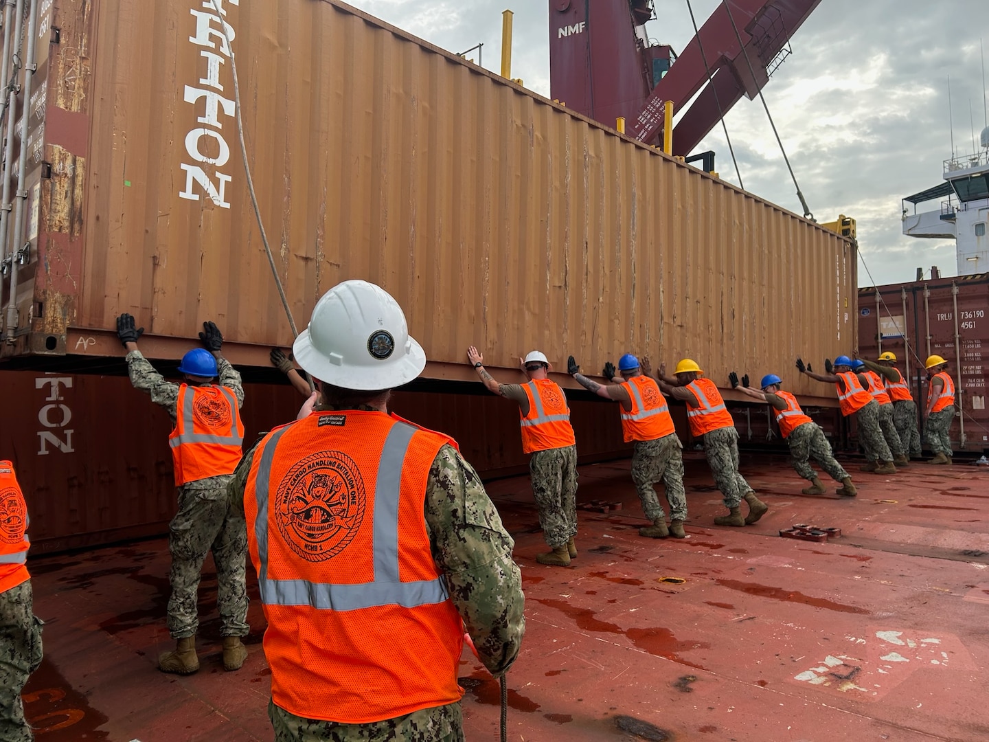 A shipping vessel being loaded with a cargo container