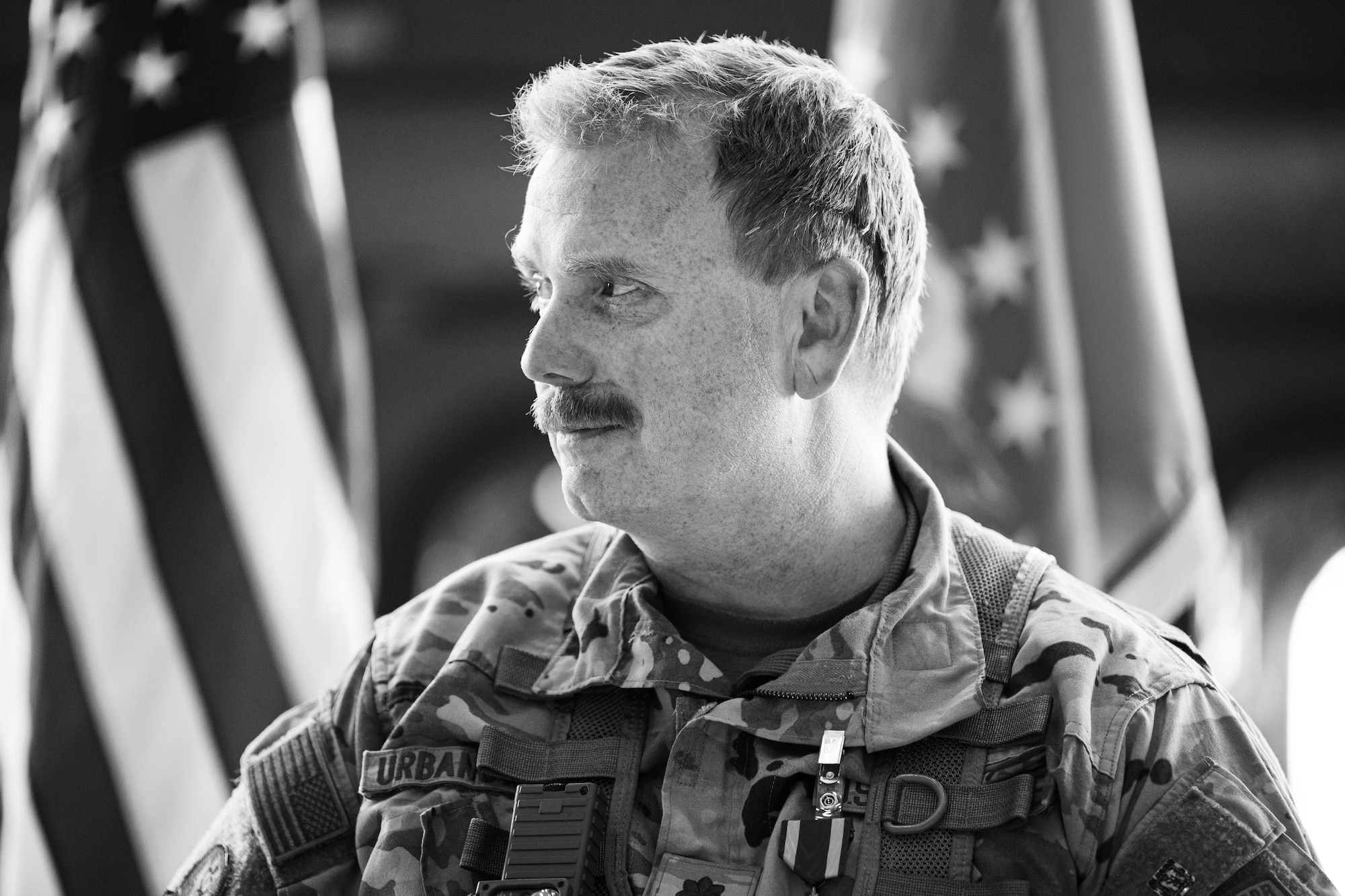 A man in uniform smiles.