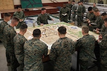 U.S. Marine Corps Capt. Zachary Toney, a staff platoon commander and infantry officer with The Basic School, Training Command, center, issues a combat order to students with Company D, Basic Officer Course 4-25, during the warfighting field exercise at TBS, Marine Corps Base Quantico, Virginia, Nov. 17, 2025. The WARFEX serves as the culminating event at TBS, evaluating students’ proficiency in decision-making, small-unit tactics, and leadership as they operate under sustained physical and mental pressure in a realistic warfighting scenario. (U.S. Marine Corps photo by Cpl. Joshua Barker)