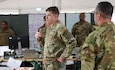 Members of the 200th Military Police Command conduct a shift change briefing during Avenger Triad 25 (AvT25) at Grafenwohr, Germany, 27 Oct. 2025. AvT25 is a U.S. Army Europe-Africa Command computer assisted command post exercise designed to train U.S. and multinational units in large scale combat operations in a competitive simulated environment. (U.S. Army photo by Staff Sergeant Arthur Ruepong)