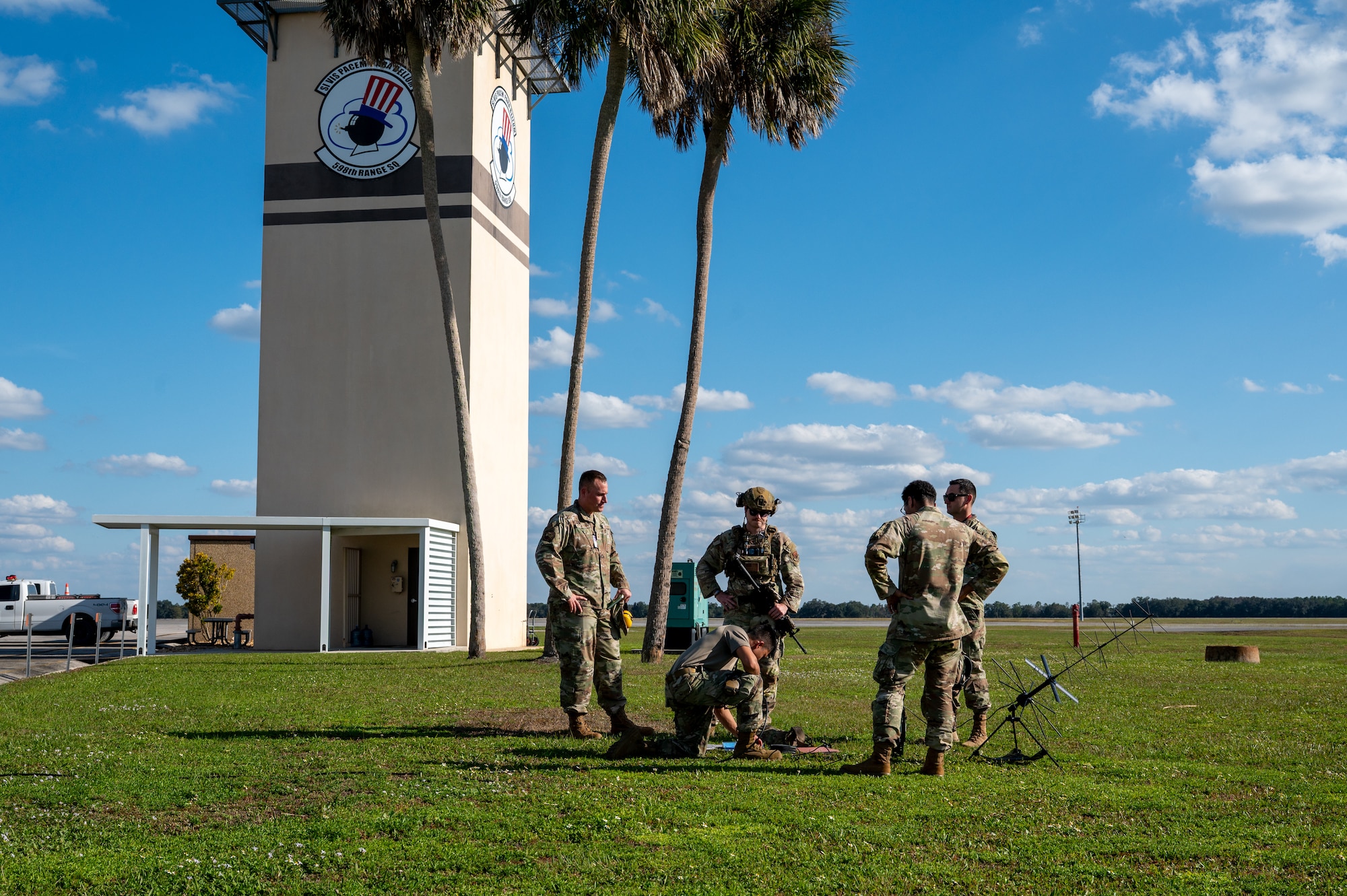 Group of men watch another work.