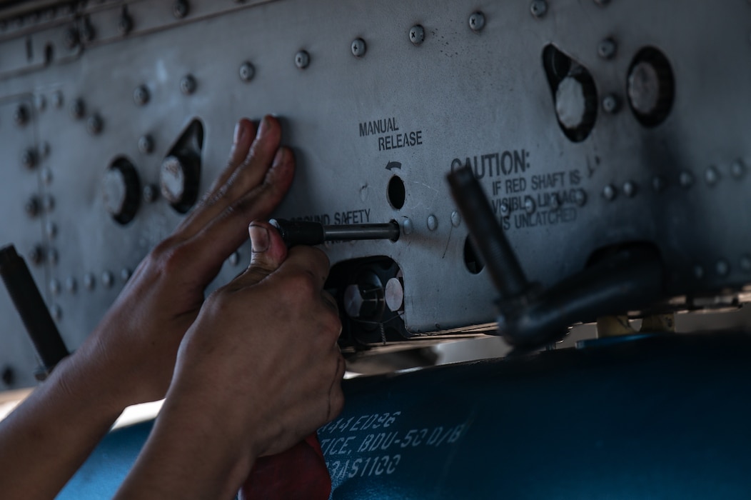 Clos up of hands turning wrench.