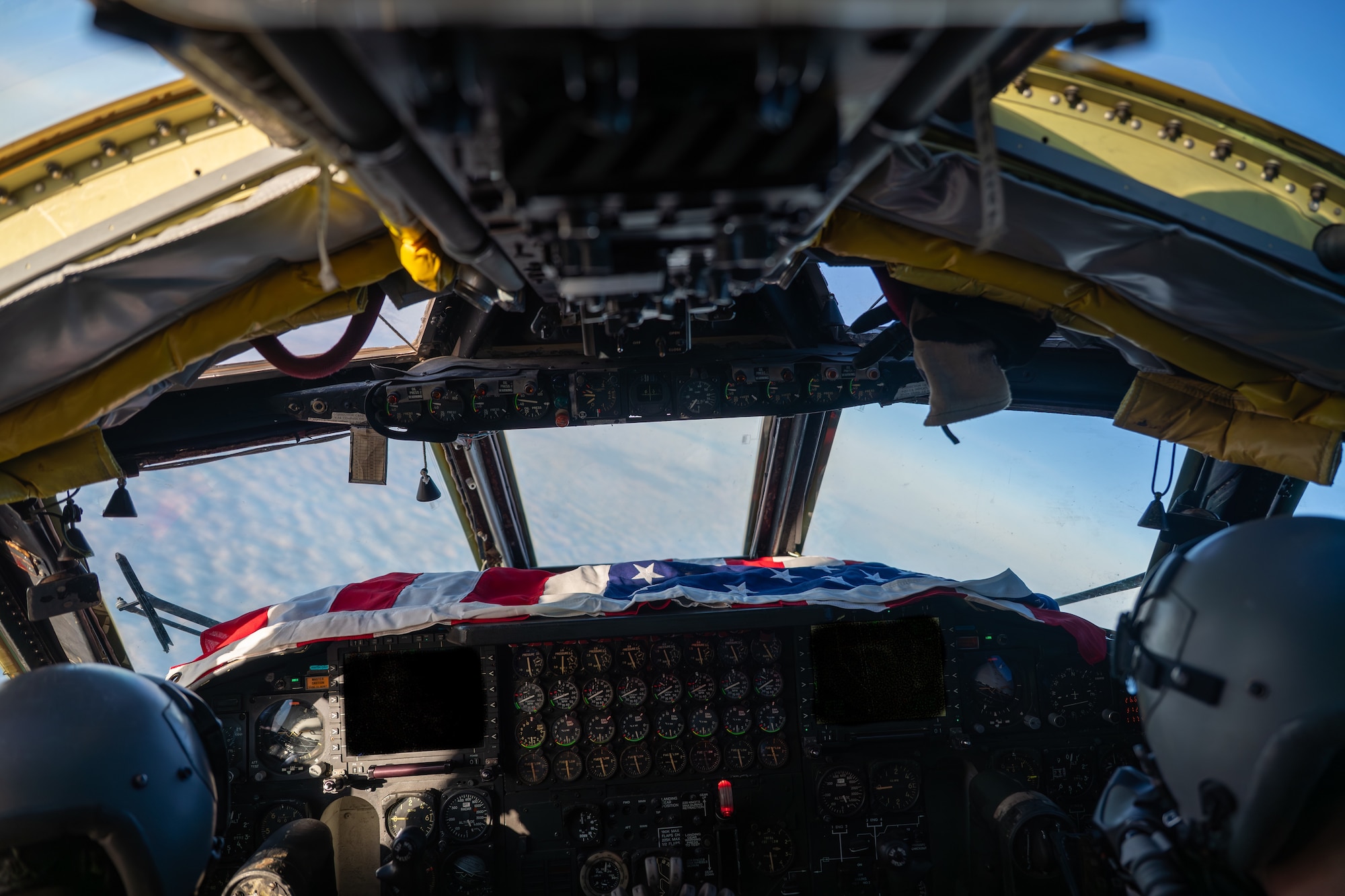 The interior of a B-52 with a flag on the dashboard.