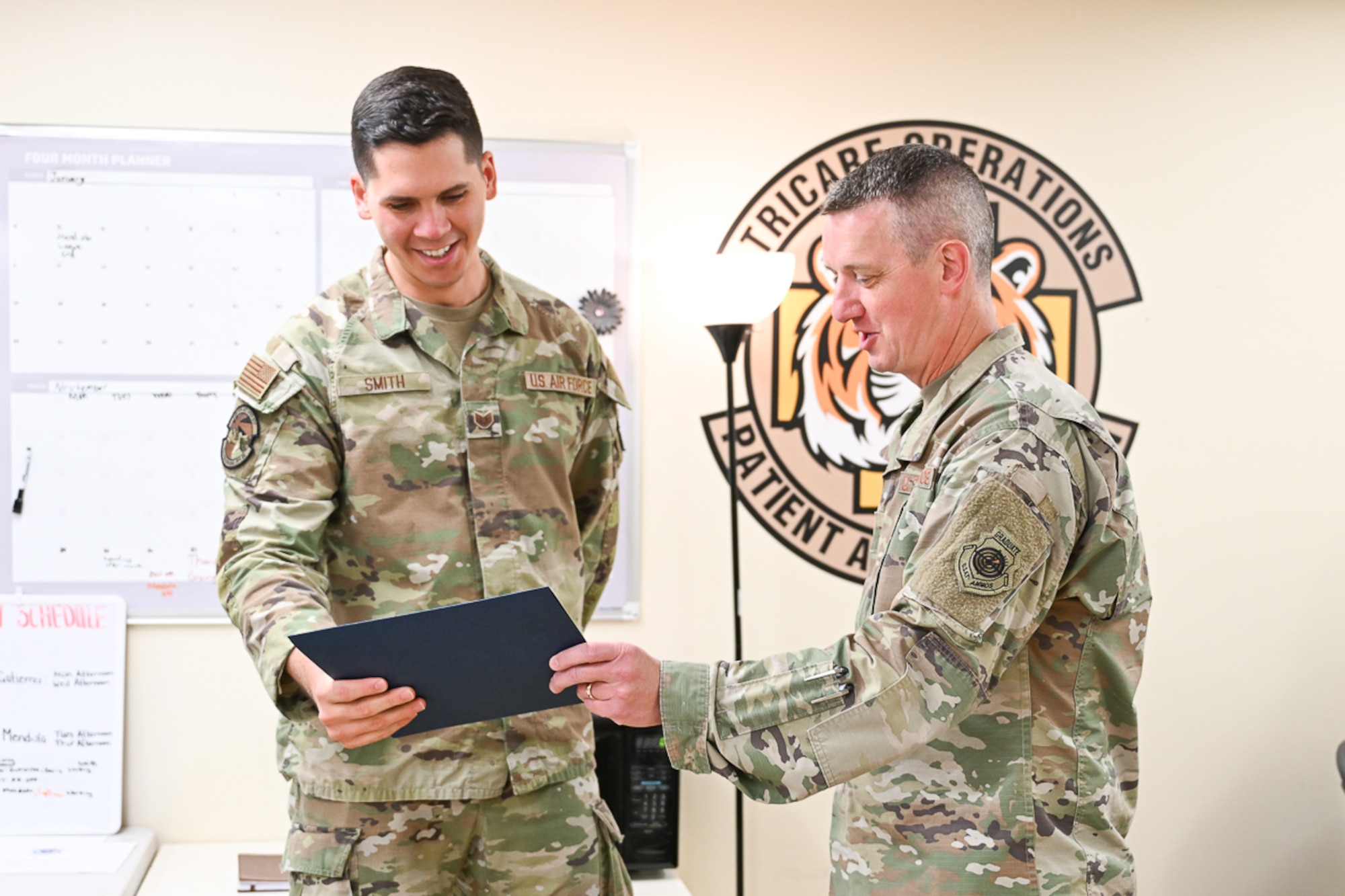 Tech. Sgt. Zachary R. Smith of the 75th Medical Group receives a certificate from Col. Daniel Cornelius, 75th Air Base Wing commander.